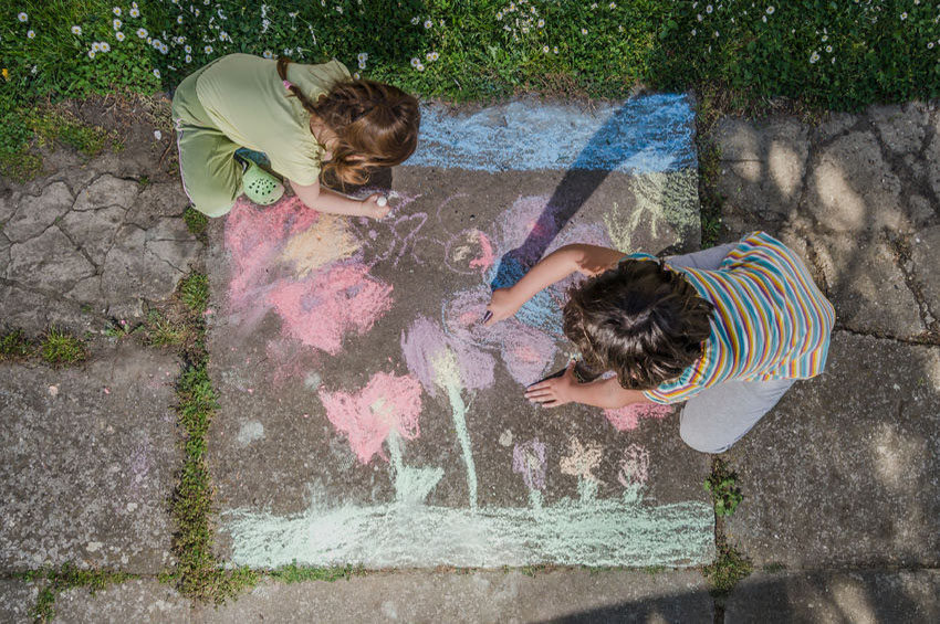 40266160 - two happy creative kids drawing with chalk on sidewalk